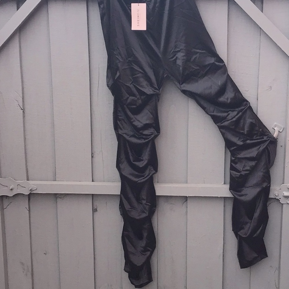 Black shiny high waisted stacked pants.Side zipper just a few inches.